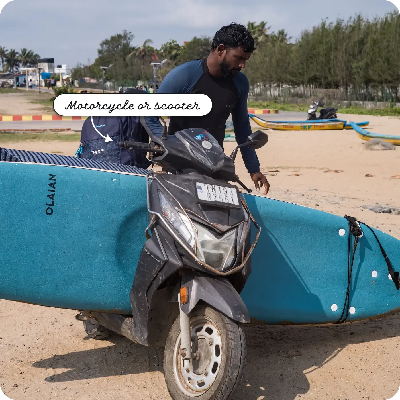 A man wearing a helmet sitting on a two-wheeler. A label points to the handlebars as a "Motorcycle or scooter".