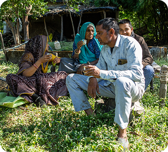 Sheela and Ramprasad outside their home